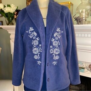 Vermont country store slate, blue embroidered fleece jacket with white flowers.